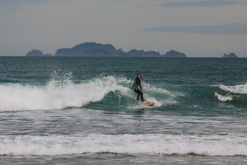A surfer surfing at Tairua