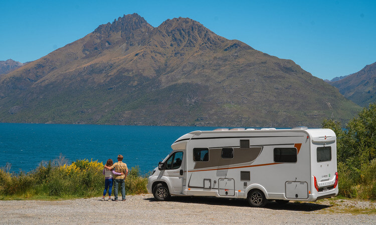 A couple stopping by Lake Wakatipu in New Zealand to enjoy the view