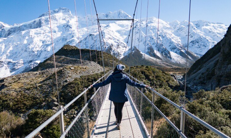 A woman trekking at the Hooker Valley Track in Aoraki Mount Cook National Park