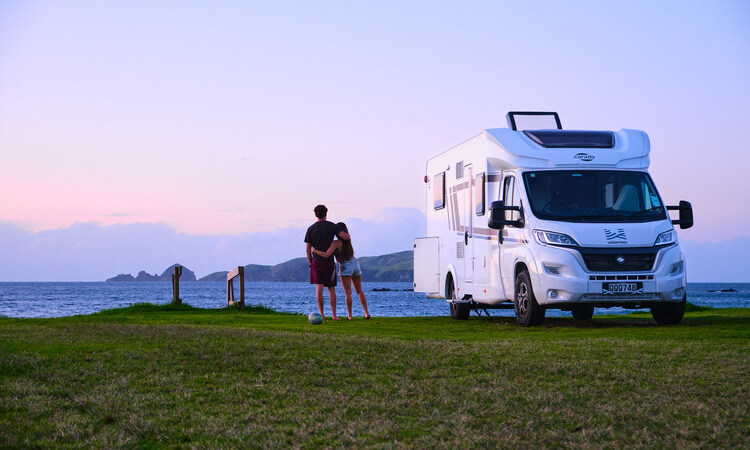 A couple having a lovely moment while enjoying the view outside of their Wilderness motorhome