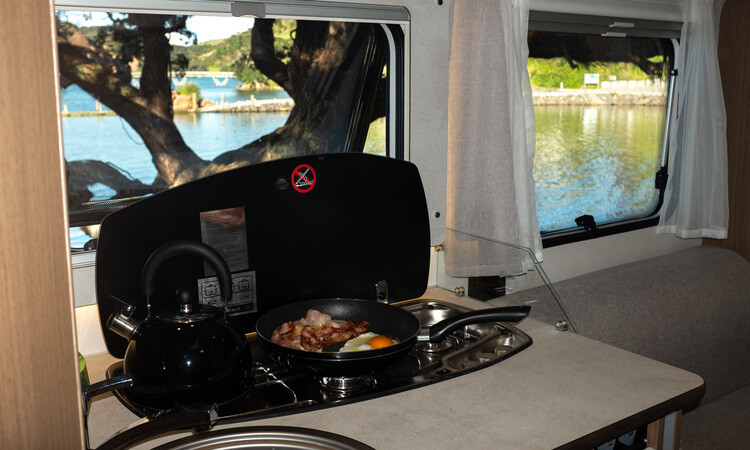 Breakfast being prepared in the kitchen of a Wilderness motorhome