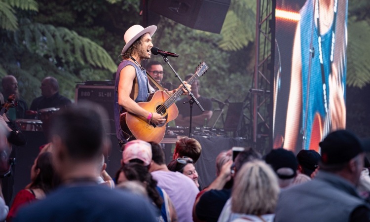 A singer performing at a music festival in Taranaki