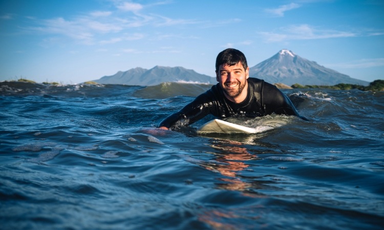 A surfer surfing at Taranaki Coast near Surf Highway 45