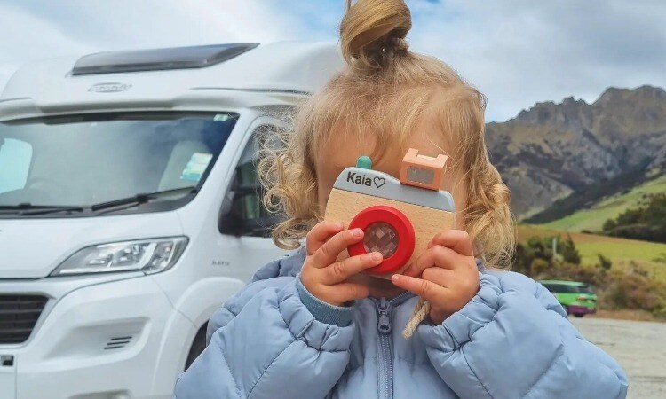 A kid playing with her toy camera