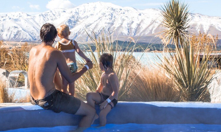 Dad and kids enjoying a hot spring with a view