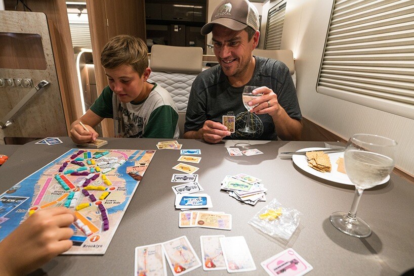 Family playing board games in motorhome lounge