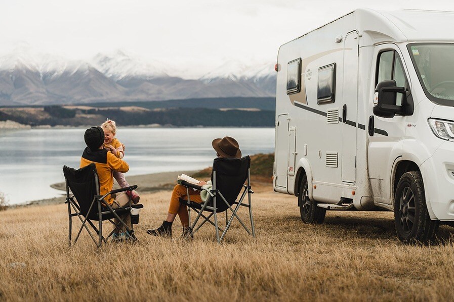 Family spending time together outside of a motorhome