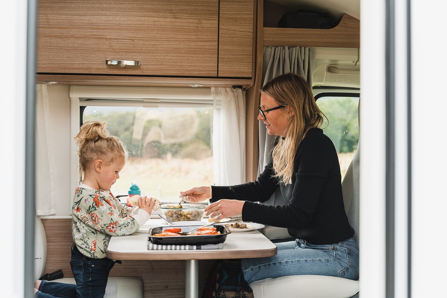 Mom and daughter enjoying a meal together in a Compact Plus