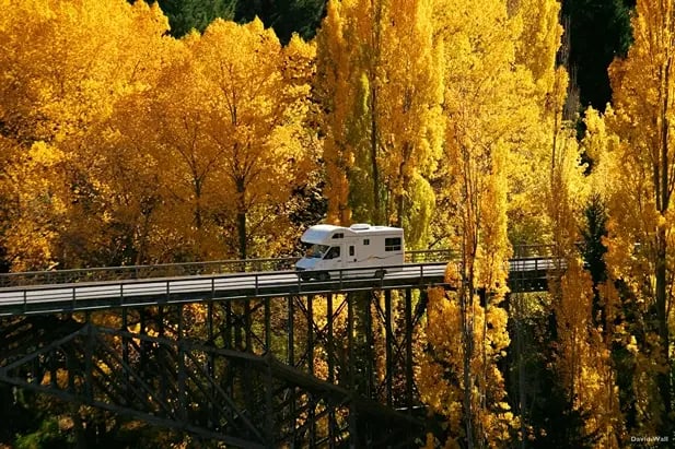 A 6-berth motorhome being driven during Autumn season